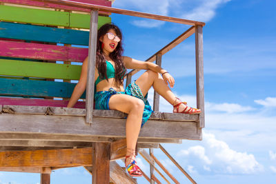 Young woman sitting on bench