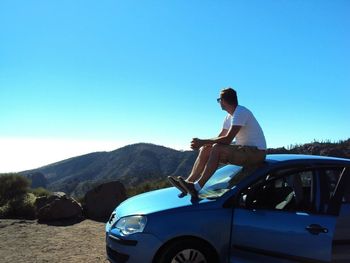 Man using mobile phone on car