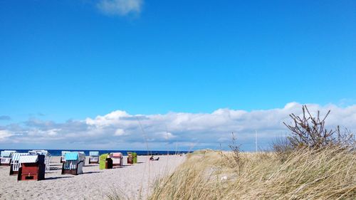 Scenic view of beach against blue sky