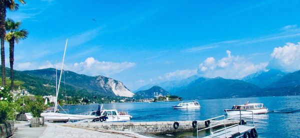 Scenic view of sea and mountains against blue sky