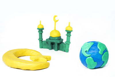 Close-up of yellow toys over white background