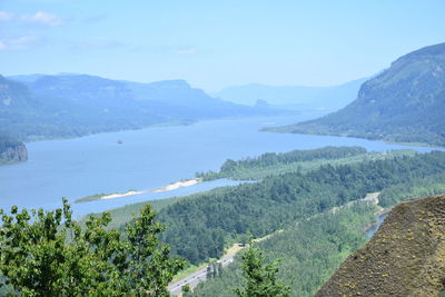 Scenic view of sea and mountains against sky