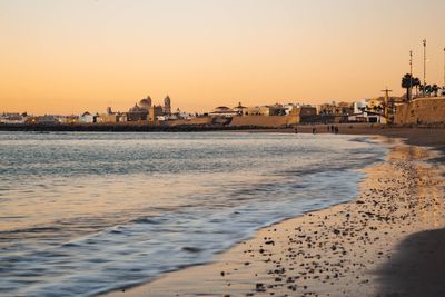 Scenic view of sea against clear sky during sunset