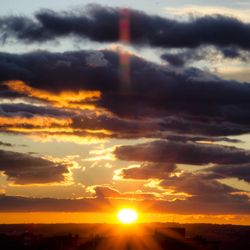 Low angle view of dramatic sky during sunset