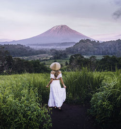 Woman standing on land against sky