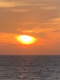 Scenic view of sea against orange sky