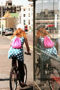 Rear view of women with bicycle