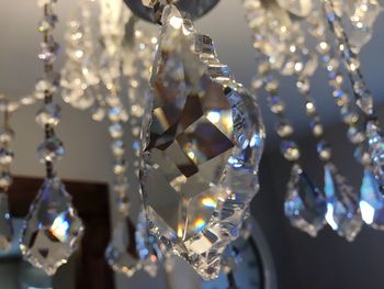 Low angle view of crystals hanging from chandelier