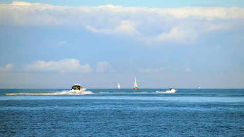 Boat sailing in sea against sky