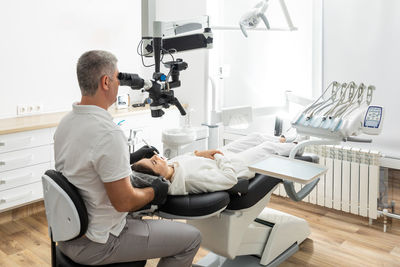 Midsection of doctor examining patient in hospital