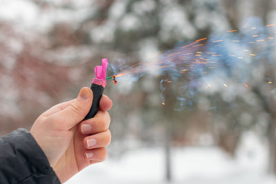 Close-up of hand holding sparkler