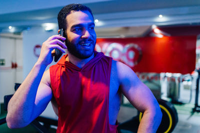 Portrait of young man standing in gym