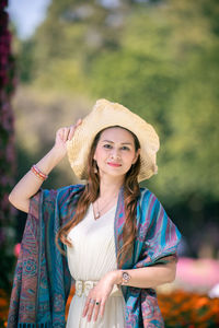 Portrait of beautiful young woman wearing hat