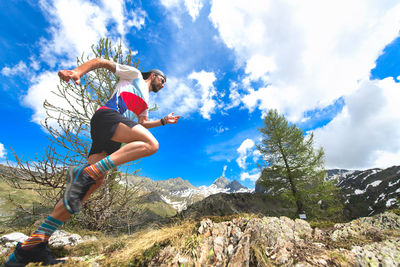 Low angle view of woman against mountain