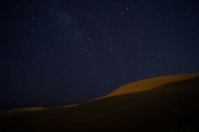 Scenic view of desert against sky at night