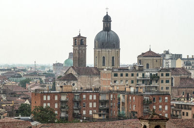 Buildings in city against clear sky