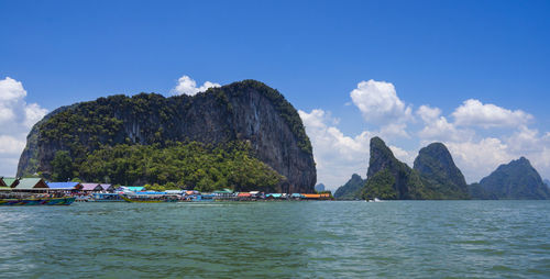 Panoramic view of sea and mountains against sky