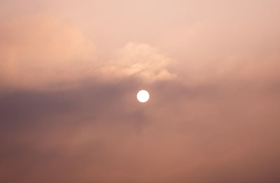 Low angle view of moon against sky at sunset