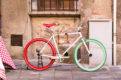 Bicycle parked against building