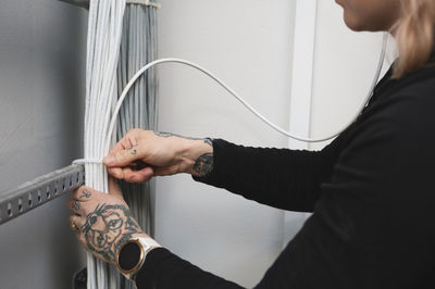 Female electrician managing cables