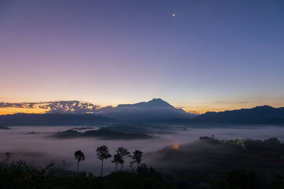 Scenic view of silhouette mountains against sky at sunset