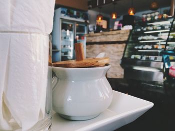 Coffee pot in plate on table at restaurant