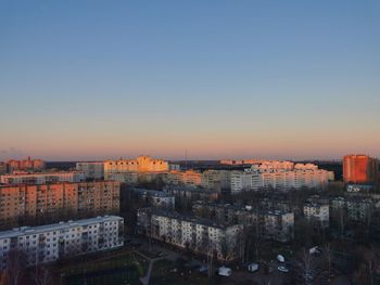 High angle view of buildings against sky at sunset