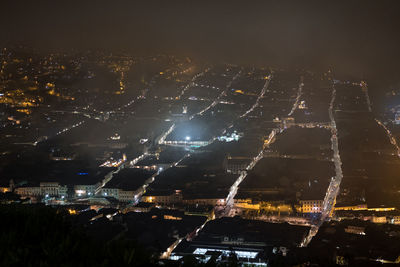 High angle view of illuminated buildings in city at night