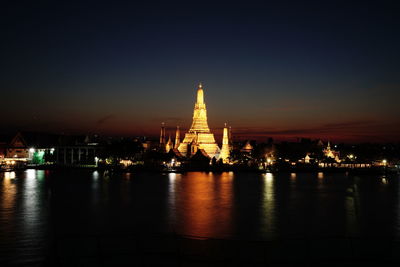 Wat arun and chao phraya river at twilight time.