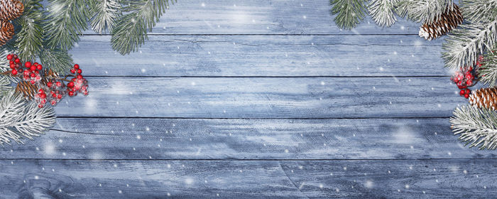 Christmas tree on wooden table against wall