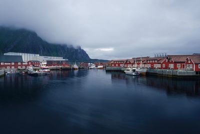 Scenic view of sea by buildings against sky