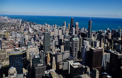 High angle view of buildings by sea in city