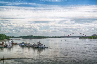 Scenic view of river against cloudy sky