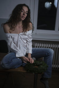 Young woman sitting at home