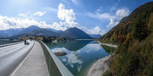 Bridge over sylvenstein reservoir, motorcycle with sidecar, impressive clouds and lake