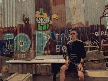 Portrait of young man sitting on table