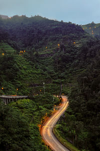 High angle view of light trails on road against sky at night