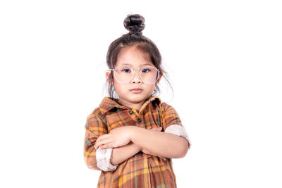 Portrait of cute girl standing against white background