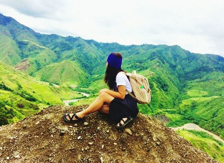 mountain, rear view, nature, sitting, casual clothing, one person, day, beauty in nature, full length, forest, outdoors, people, young adult, scenics, hiking, adult, adventure, relaxation, mountain range, tree, landscape, only women, sky, one young woman only, beautiful woman, adults only, one woman only