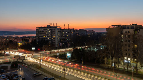 High angle view of illuminated city at sunset