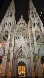 Low angle view of illuminated cathedral against sky at night