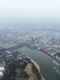High angle view of river and buildings against sky