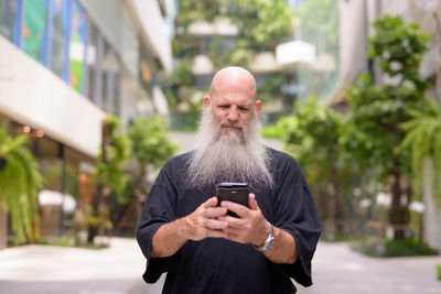 Man using mobile phone in city