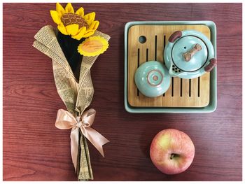 High angle view of flowers with food and drink on table