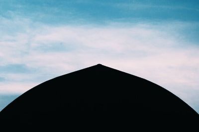 Low angle view of building against cloudy sky