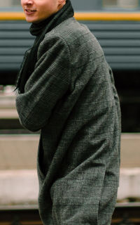 Side view of young man standing outdoors