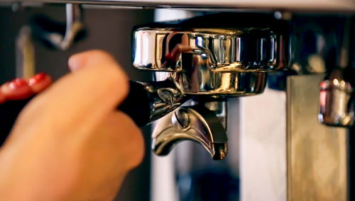 Close-up of hand holding coffee cup