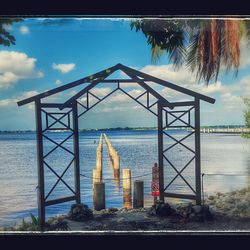 View of built structure by sea