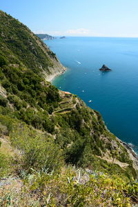 High angle view of sea and mountains against sky