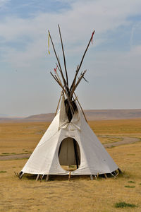 Tent on field against sky